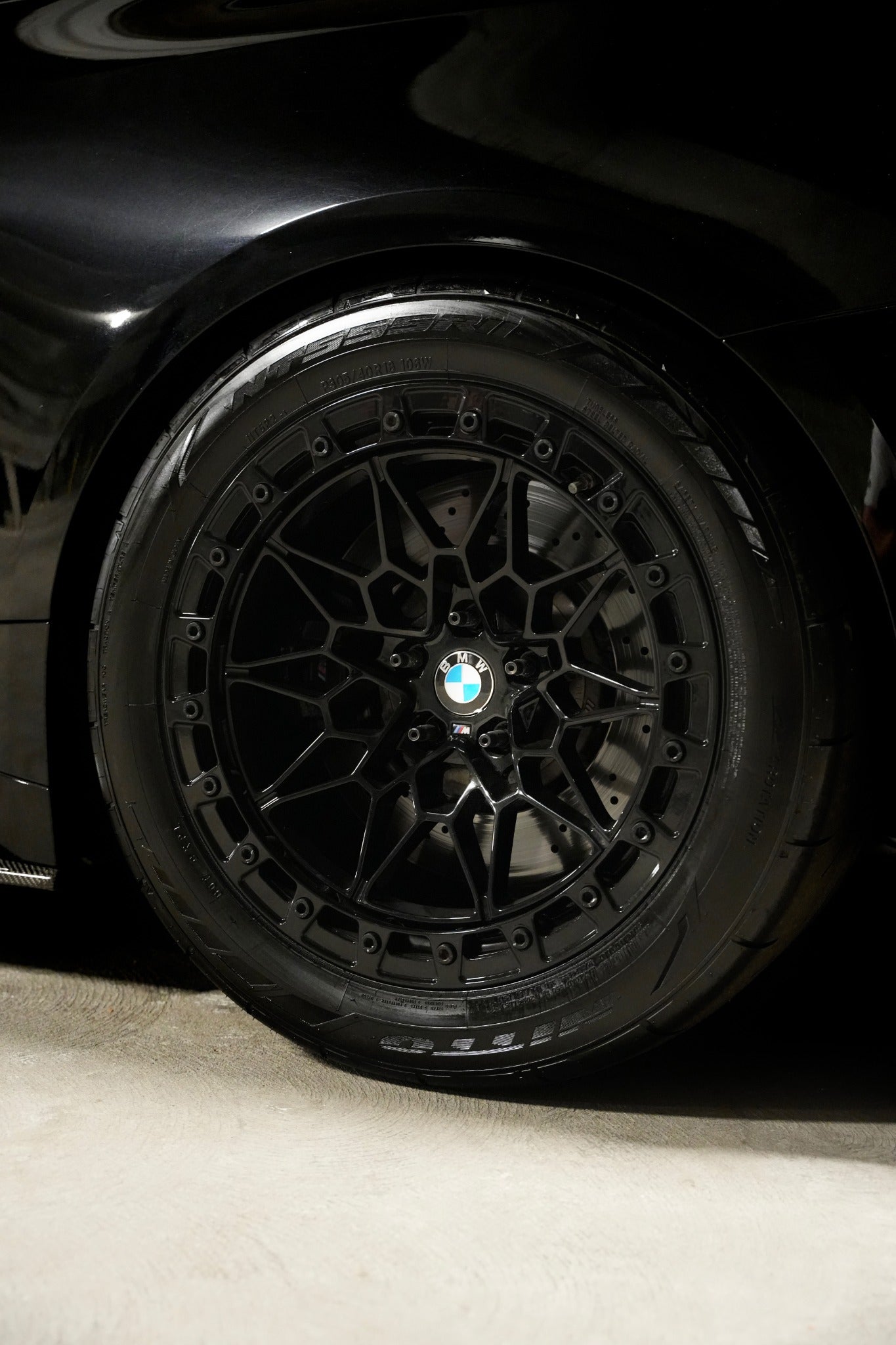 Black Ryvik Forged wheel and performance tire on a BMW